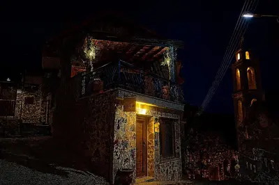 a building with a door and a tower at night at The Lodge Kampi by Thea Suites