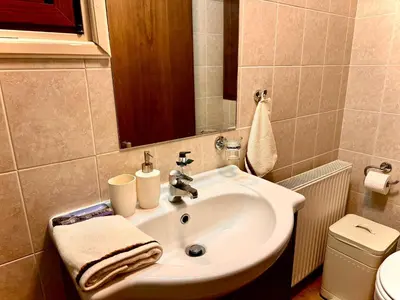 a bathroom with a sink and a toilet at The Lodge Kampi by Thea Suites