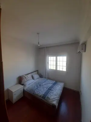 a small bedroom with a bed and a window at Daire in Kaimakli
