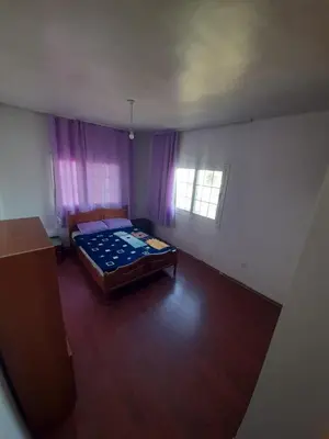 an empty room with a bed and a window at Daire in Kaimakli