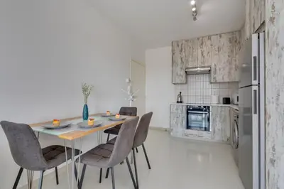 a kitchen with a table and chairs and a refrigerator at Elisabeth Salt Lake views 200m from Makenzy beach in Larnaka