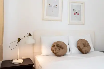 a bedroom with a bed with two pillows and a lamp at Levante - 2-BR Apt & Terrace in Larnaca in Larnaka