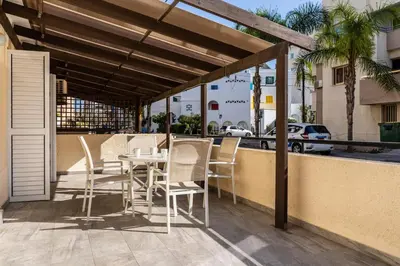 a patio with a table and chairs on a balcony at Levante - 2-BR Apt & Terrace in Larnaca in Larnaka