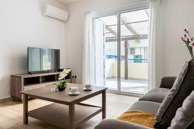 a living room with a tv and a coffee table at Levante - 2-BR Apt & Terrace in Larnaca in Larnaka