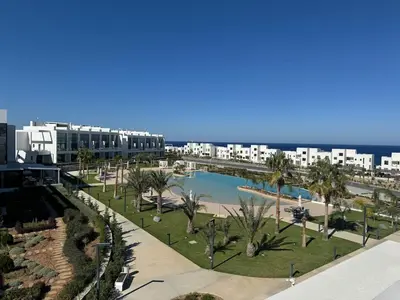 a view of a resort with a pool and palm trees at CoveDream Studio Sun Valley Esentepe in Aglantzia