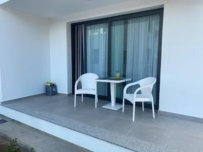 a patio with two chairs and a table on a balcony at CoveDream Studio Sun Valley Esentepe in Aglantzia