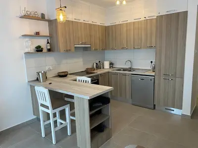 a kitchen with wooden cabinets and a wooden counter top at CoveDream Studio Sun Valley Esentepe in Aglantzia