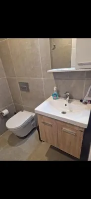 a bathroom with a white sink and a toilet at CoveDream Studio Sun Valley Esentepe in Aglantzia