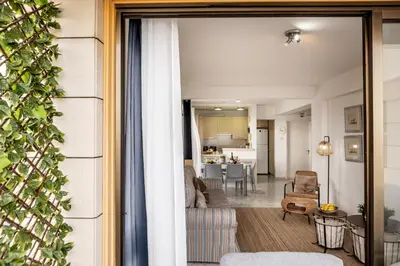 a view of a living room and a dining room at Mackenzie Beachfront Suite in Larnaka