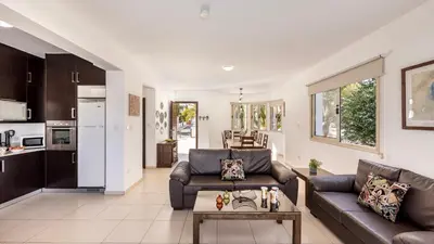 a living room with a couch and a table at EcoHarmony Villa in Paralimni