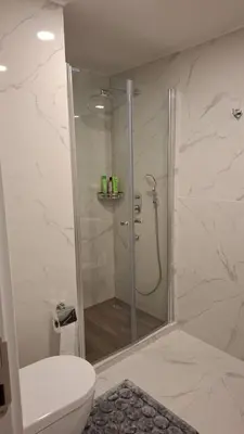 a bathroom with a shower and a toilet at Grand Sappfıre Resort Iskele in Larnaka