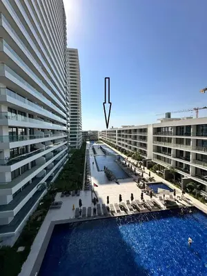 a large building with a swimming pool next to a building at Grand Sappfıre Resort Iskele in Larnaka