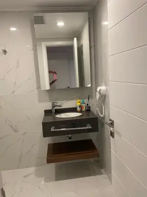 a bathroom with a sink and a mirror at Grand Sappfıre Resort Iskele in Larnaka