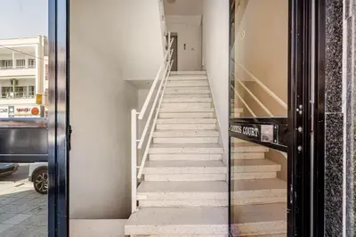 a staircase in a building with a glass door at Urban Bay Studios in Limassol