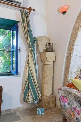 a room with a curtain on the wall and a window at The Historical Cypriot House, Beautifully Renovated Traditional Stone House in Ayios Ioannis