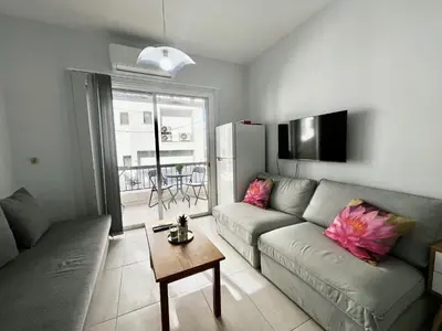 a living room with a couch and a table at STAY McKenzie Mile in Larnaka