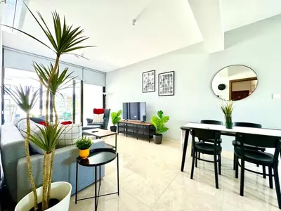 a living room with a couch and a table with plants at Bright & cozy apartment in Livadia in Livadhia