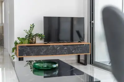 a flat screen tv sitting on top of a entertainment center at New 2 bedroom flat in Aglantzia in Aglantzia