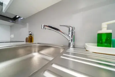 a kitchen sink with a green bottle on it at New 2 bedroom flat in Aglantzia in Aglantzia