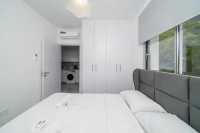 a white bedroom with a bed and a couch at New 2 bedroom flat in Aglantzia in Aglantzia