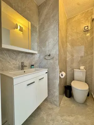 a bathroom with a white sink and a toilet at Napa Skyline Suite 3BR Sunset Views and Pool in Ayia Napa