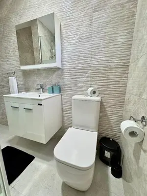 a bathroom with a white toilet and a sink at Napa Skyline Suite 3BR Sunset Views and Pool in Ayia Napa