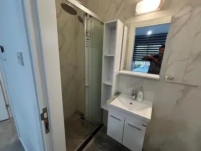 a bathroom with a sink and a shower and a mirror at Veray Homes, Alsancak in Ayios Dhometios
