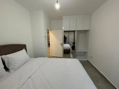 a bedroom with a large white bed and a room at Veray Homes, Alsancak in Ayios Dhometios