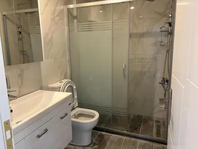 a bathroom with a shower and a toilet and a sink at Veray Homes, Alsancak in Ayios Dhometios