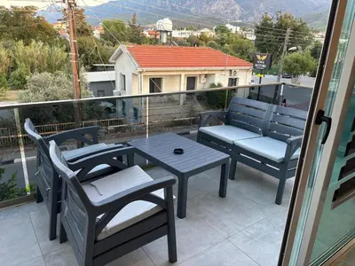 a patio with a table and chairs on a balcony at Veray Homes, Alsancak in Ayios Dhometios