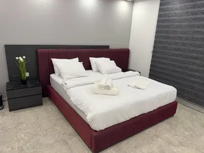 a bedroom with a bed with two towels on it at Veray Homes Villa in Ayios Dhometios