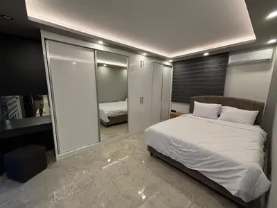 a bedroom with a large bed and a mirror at Veray Homes Villa in Ayios Dhometios