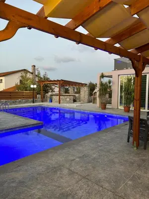 a large swimming pool with blue water at Veray Homes Villa in Ayios Dhometios