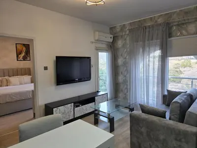 a living room with a television and a couch at White Arches Haven by Staycom in Limassol