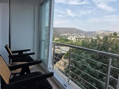 a balcony with a table and chairs and a view at White Arches Haven by Staycom in Limassol