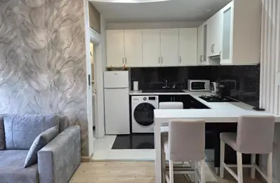 a kitchen with a couch and a table in a room at White Arches Haven by Staycom in Limassol