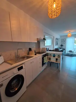 a kitchen with a sink and a washing machine at Lazuli City Center Ap 11 in Larnaka