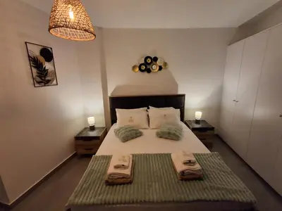 a bedroom with a bed with two towels on it at Lazuli City Center Ap 11 in Larnaka
