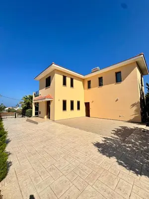 a large house with a driveway in front of it at Aurora Gardens Villa Spacious 3 Bedroom in Protaras in Paralimni