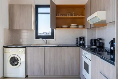a kitchen with a sink and a dishwasher at Averna - Breezy 2-BR Apt & Balcony in Larnaca in Larnaka