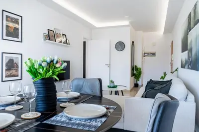 a dining room with a table and a couch at Averna - Breezy 2-BR Apt & Balcony in Larnaca in Larnaka