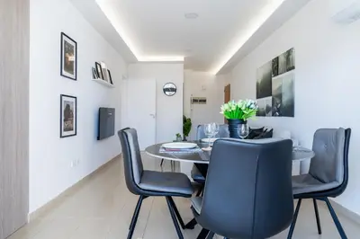 a dining room with a table and chairs at Averna - Breezy 2-BR Apt & Balcony in Larnaca in Larnaka