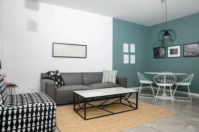 a living room with a couch and a table at Bright 2BR by Pedieos Park, near Old Town in Nicosia