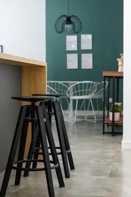 a group of stools in a room with a blue wall at Bright 2BR by Pedieos Park, near Old Town in Nicosia