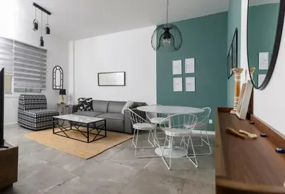 a living room with a couch and a table at Bright 2BR by Pedieos Park, near Old Town in Nicosia