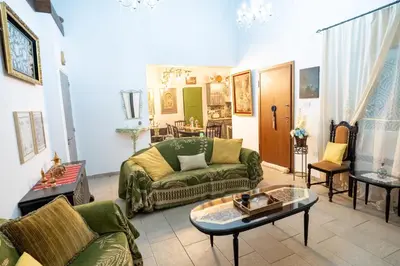 a living room with green couches and a table at Gazingstars Cottages Agridia