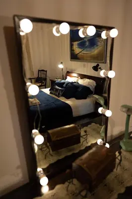 a bedroom with a bed and a large mirror at Gazingstars Cottages Agridia