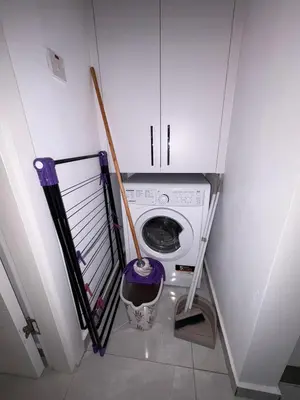 a washer and dryer in a small room at Lapta Purple 2 bedroom in Peristerona