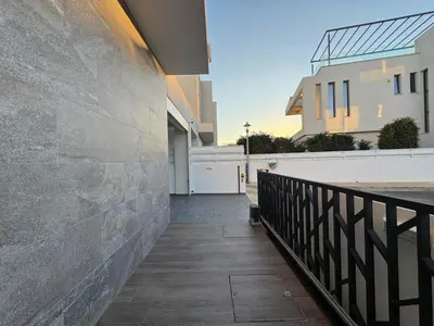 a walkway in a house with a stone wall at Sunrise Pearl - 2 min walk to Sirena Bay in Paralimni
