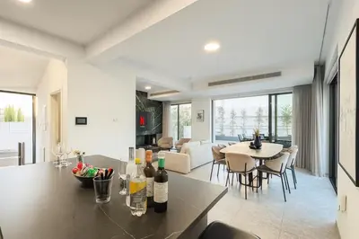 a kitchen and living room with a table and chairs at Sunrise Pearl - 2 min walk to Sirena Bay in Paralimni